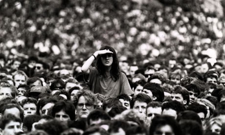 a woman hovering over a crowd of people