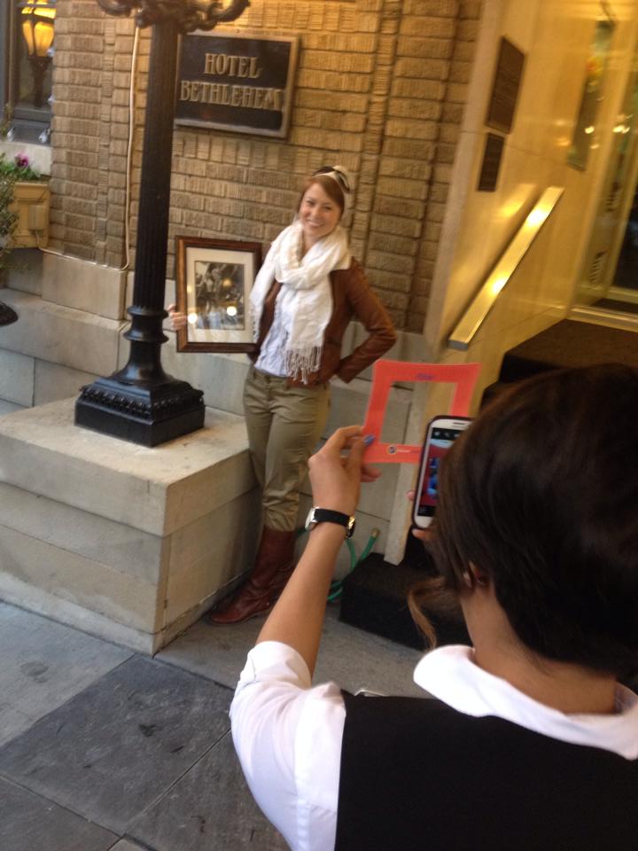 a women getting her picture taken in a frame holding a picture