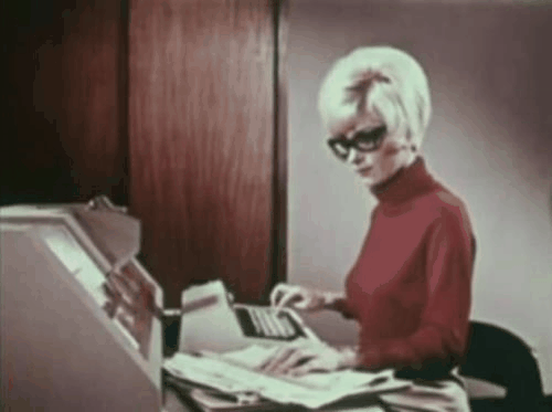 A gif of a woman typing on a type writer