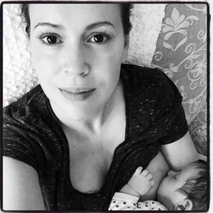 A black and white photo of a woman breastfeeding her baby