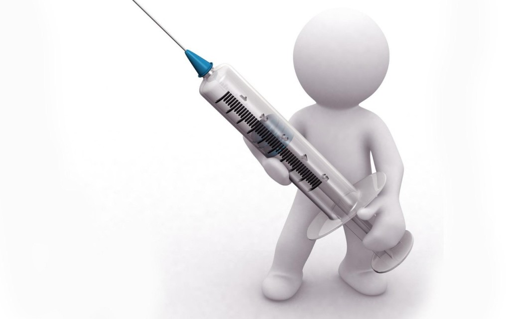 A statue holding a vaccine needle