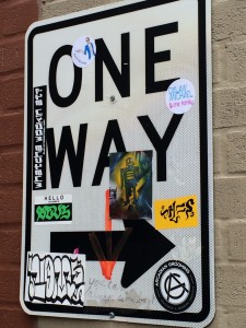 One way sign covered in stickers