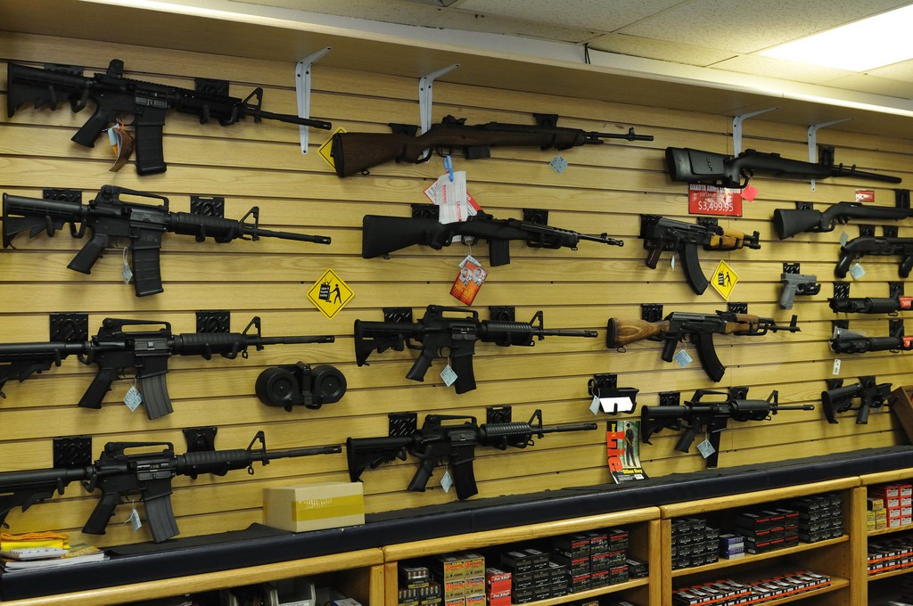 Guns hanging on a wall in a store