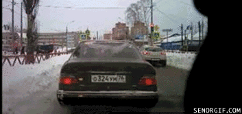 A gif of a man getting out of his car hitting his blinker