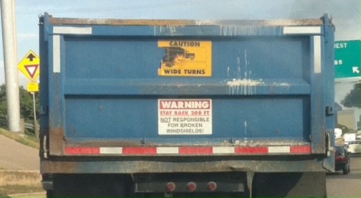 An image of the back of a blue dump truck
